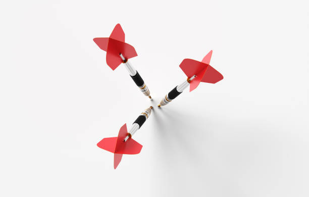 istock Three red darts hitting center of target on white background 2186729206
