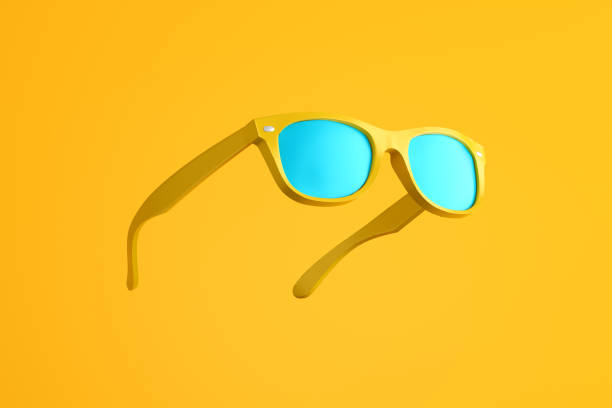 istock Yellow sunglasses floating on vibrant yellow background representing summer vibes 2186729322