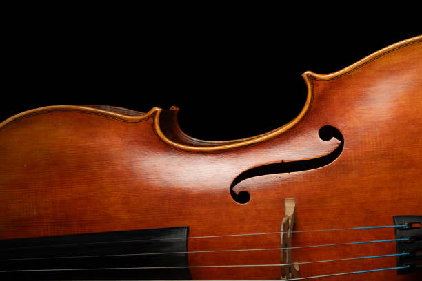 istock cello front close up, classical music background, classic string instrument, violin texture wooden backgrounds, musical instrument on a dark black background 2186730784