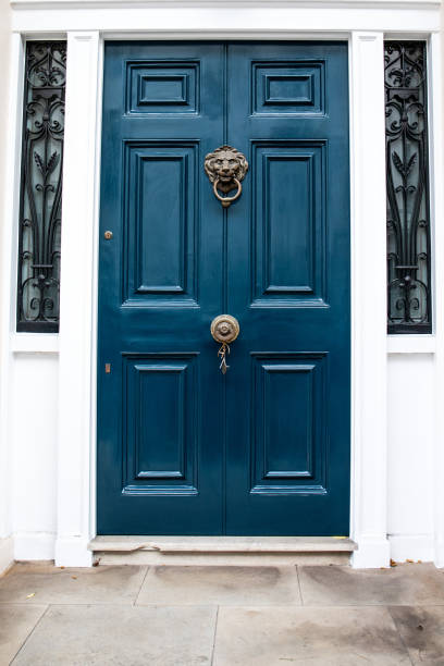 istock Sophisticated blue building door with lion image on door knocker, architectural design 2186731282