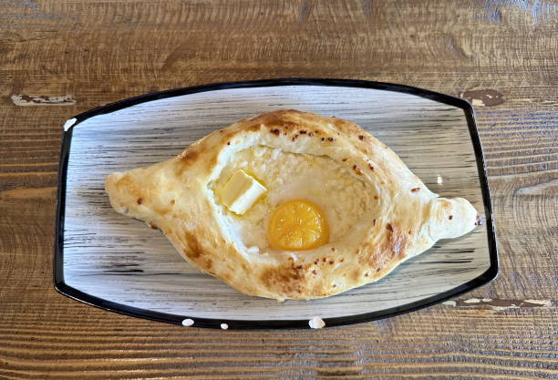 istock Georgian khachapuri in a plate on a wooden table 2186734570