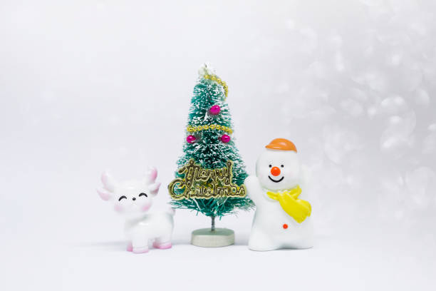 istock Cute white reindeer and happy snow man with Christmas tree on white background 2186736137