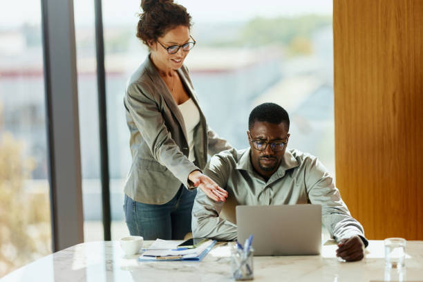 istock Diverse business colleagues reading an e-mail on laptop in the office. 2186737583