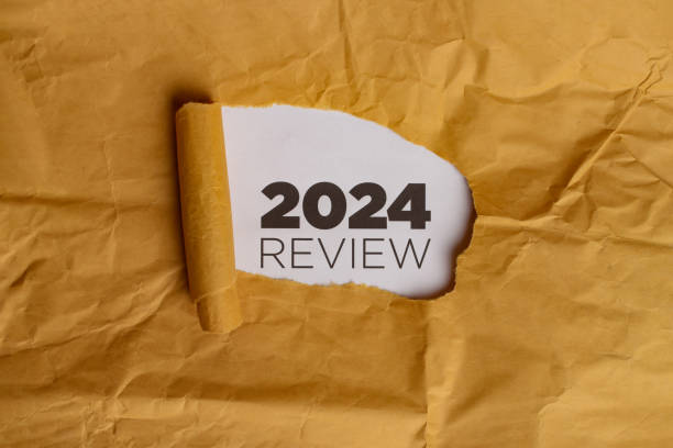 istock Yellow Paper with Hole Revealing 2024 REVIEW Text 2186738919