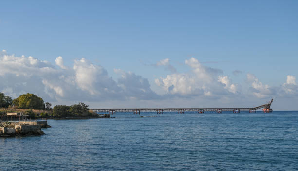 istock Vast blue waters meet a distant pier under a bright sky in a serene coastal landscape 2186738988