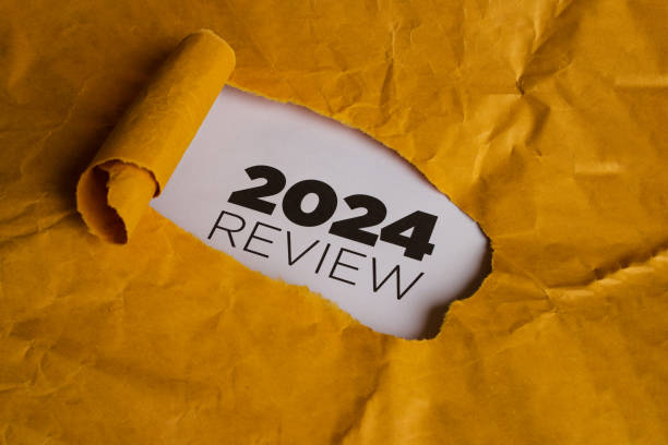 istock Yellow Paper with Hole Revealing 2024 REVIEW Text 2186739239