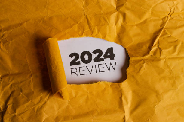 istock Yellow Paper with Hole Revealing 2024 REVIEW Text 2186739266