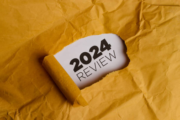 istock Yellow Paper with Hole Revealing 2024 REVIEW Text 2186740901