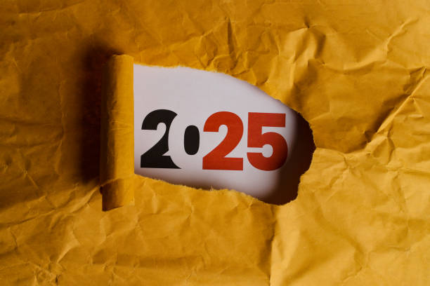 istock 2025 Revealed Through Torn Hole in Yellow Paper 2186741113