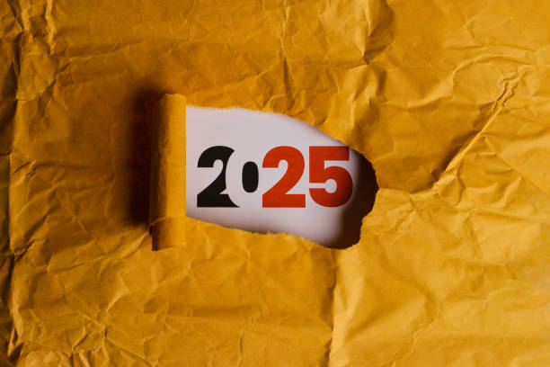 istock 2025 Revealed Through Torn Hole in Yellow Paper 2186741130