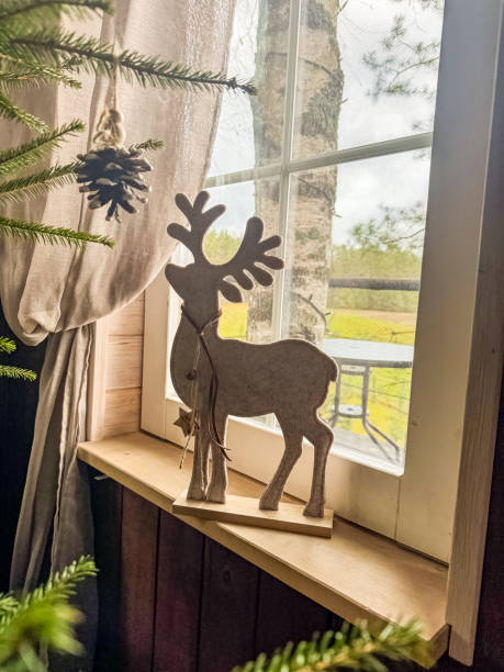 istock Rustic Wooden Reindeer Decoration by Window with Cozy Natural View 2186741929