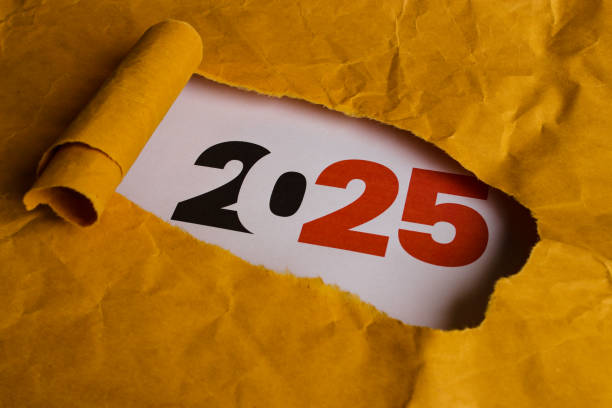 istock 2025 Revealed Through Torn Hole in Yellow Paper 2186741940