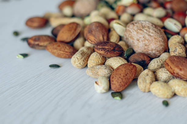 Assortment of nuts on white wood table