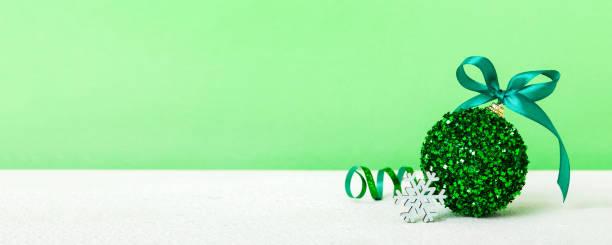 istock Christmas ball on colored background. decoration bauble with ribbon bow with copy space 2186742859