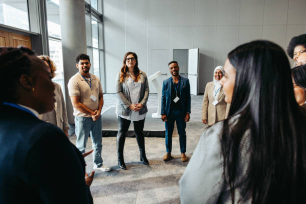 istock Diverse business professionals discussing during team building event in modern office space 2186743021