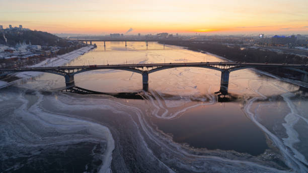 istock Bridge over a frozen river with a beautiful sunset in the background 2186745866