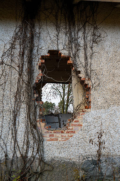 istock Old house with big hole in brick wall 2186746354
