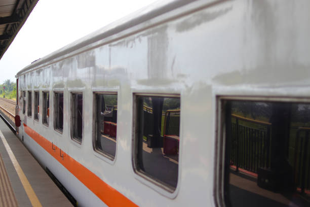 A close-up view of a train car parked at a station platform in Indonesia.