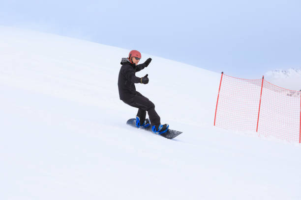 istock Snowboarding   Man  snowboarding  on the mountain ski slope 2186747438