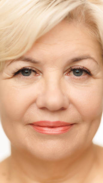 istock Frontal shot of woman's face, highlighting her blue eyes with long lashes against white studio background. Well-kept, shining skin. 2186747795