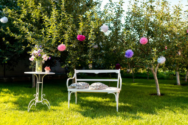 istock White Bench and Table in a Summer Garden 2186748101