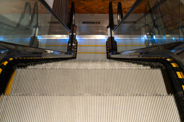 Escalator, lens flare and empty airport building for morning travel, journey or stairway entrance for flight, departure or arrival. Interior, machine or moving steps at modern shopping mall or office.