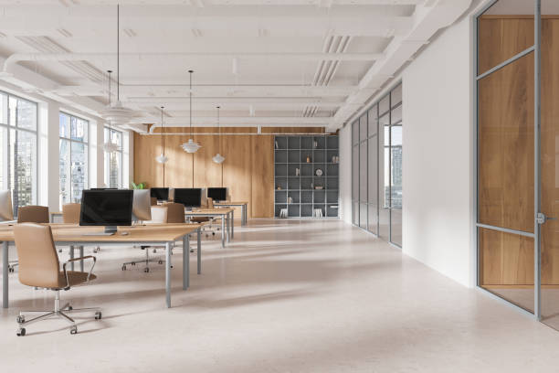 istock Spacious modern open space office with desks, chairs, computers, and city view through large windows in a loft-style interior. Concept of coworking. 3D Rendering 2186750089
