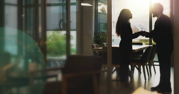 istock People, meeting and handshake for welcome in office with partnership, introduction and interview success. Silhouette, staff and agreement with promotion offer, onboarding greeting and b2b opportunity 2186750118