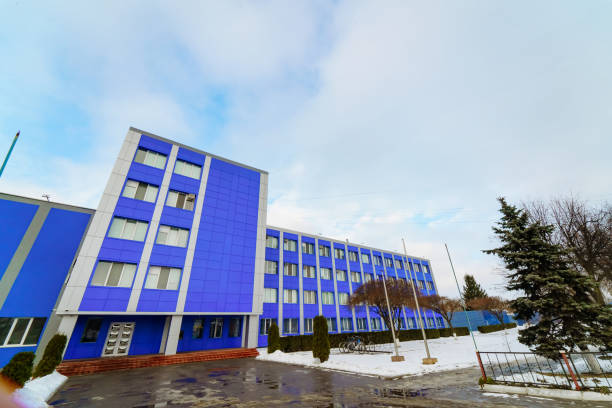 istock Modern blue building surrounded by snow in a winter landscape. A vibrant blue structure stands tall amid snow, showcasing a winter day with cloudy skies. 2186750663