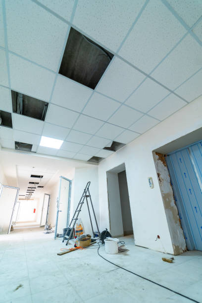 istock Renovation work in progress in a modern office corridor. The corridor is being renovated, featuring missing ceiling tiles and construction tools placed around. 2186750732