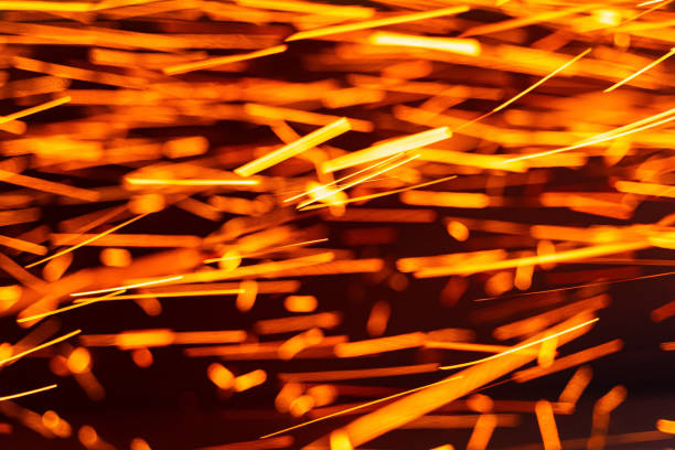 Sparks shimmer and flicker mid-flight, caught in a brief moment of combustion.