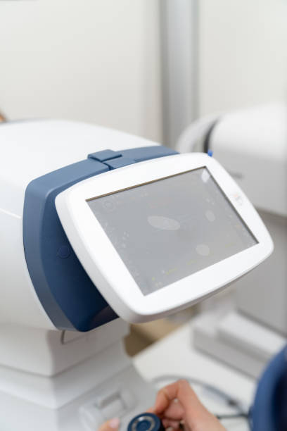 istock Ocular imaging device for eye exams. A digital ocular imaging device is being operated in a modern clinic for eye examinations, assisting in patient diagnostics. 2186751902