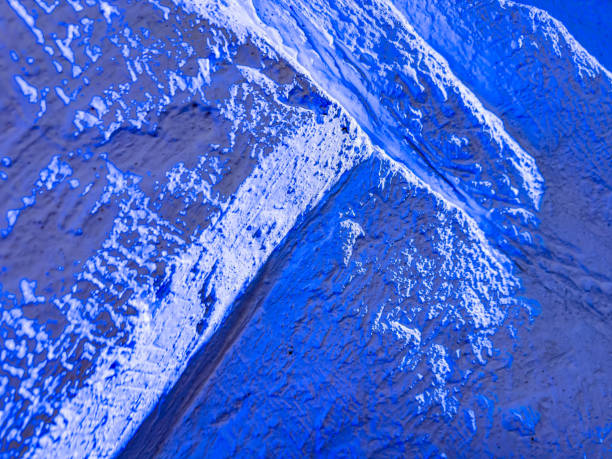 Blue texture like mountain terrain. A vivid blue surface displays unique textures and patterns, evoking a sense of depth and dimensionality in an artistic composition.
