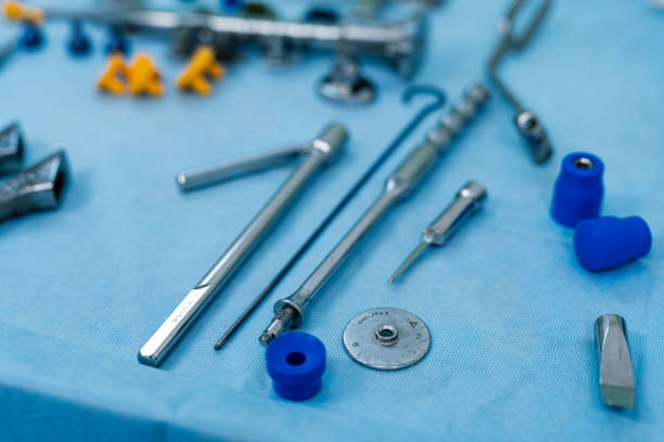 istock Surgical tools on a blue surface. A collection of surgical instruments and tools neatly arranged on a sterile blue surface. The setup is ready for a medical procedure. 2186752576