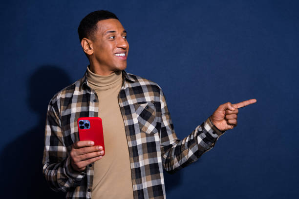 istock Photo of attractive young man look point empty space device dressed stylish checkered clothes isolated on dark blue color background 2186753226