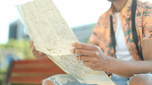 istock Tourist reading a map while traveling in a city 2186753580