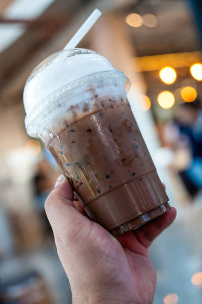 istock Hand holding iced Mocha coffee in plastic glass. 2186756135