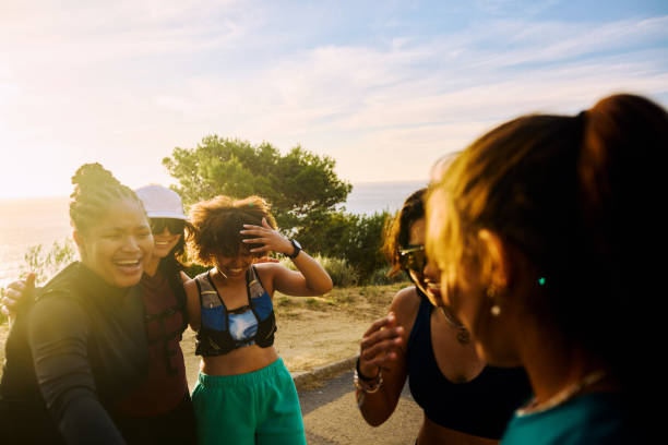 Group of gen z runners laughing together after a workout