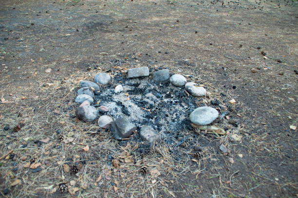 An abandoned place with an old fire pit. A campsite with a prepared fire pit in a forest camp. Old campfire.