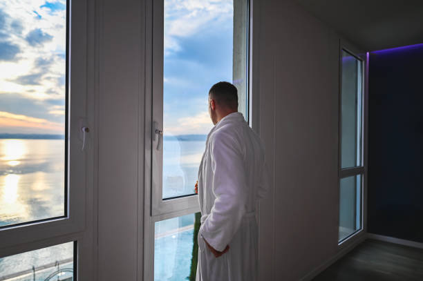 istock Tourist man enjoying sea view looking throw window. 2186758992