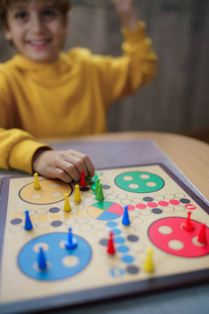 istock Boy playing Ludo game at home 2186761132