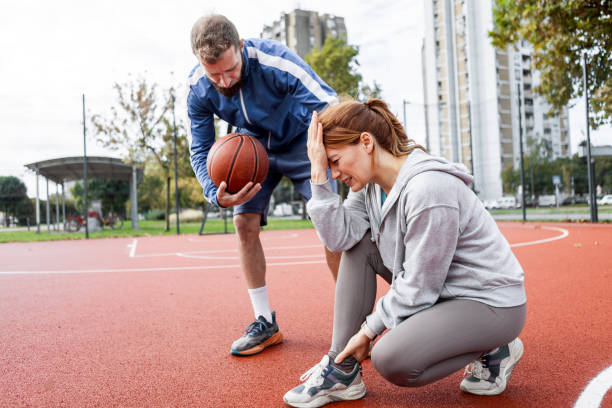 istock Caring Partner Assists Girlfriend Post-Game Injury 2186763797