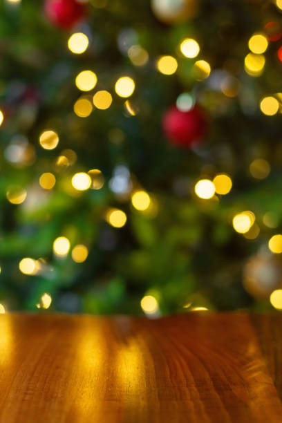 istock Christmas tree lights and wooden table background 2186764198