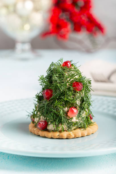 istock Portioned tuna pate on cracker decorated with dill and pomegranate seeds. Christmas appetizer in shape of Christmas tree. 2186764282