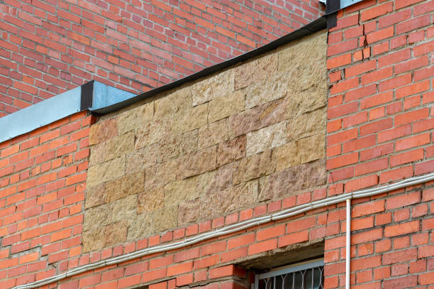 Hole in brick wall was repaired with bricks of different color.