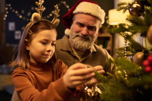 istock Enjoying Christmas Eve Decorating Christmas Tree Together 2186765686