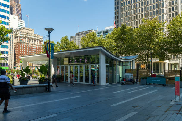 Philadelphia, Pennsylvania. USA - Ago 12th 2024: A large building with a sign that says Cafe on it. There are several people walking around the area