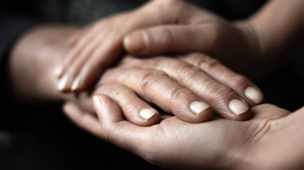 istock Close up Young woman's hand holding an old woman's hand 2186769002