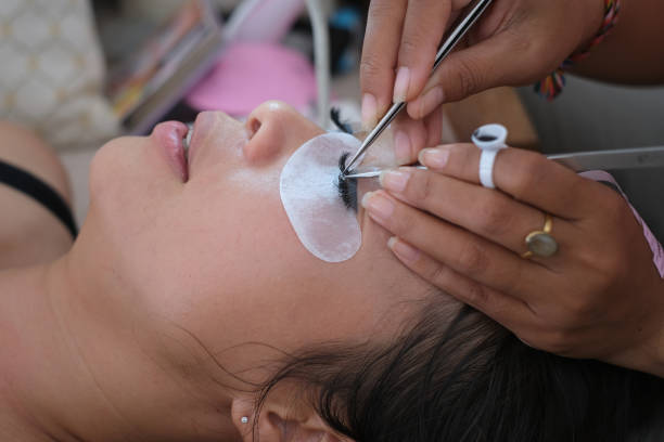 istock Unrecognizable Beautician Doing Home Service Eyelash Extension 2186769086