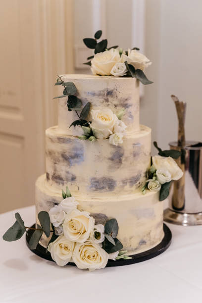 istock Elegant Three-Tier Wedding Cake with White Roses and Eucalyptus 2186769635